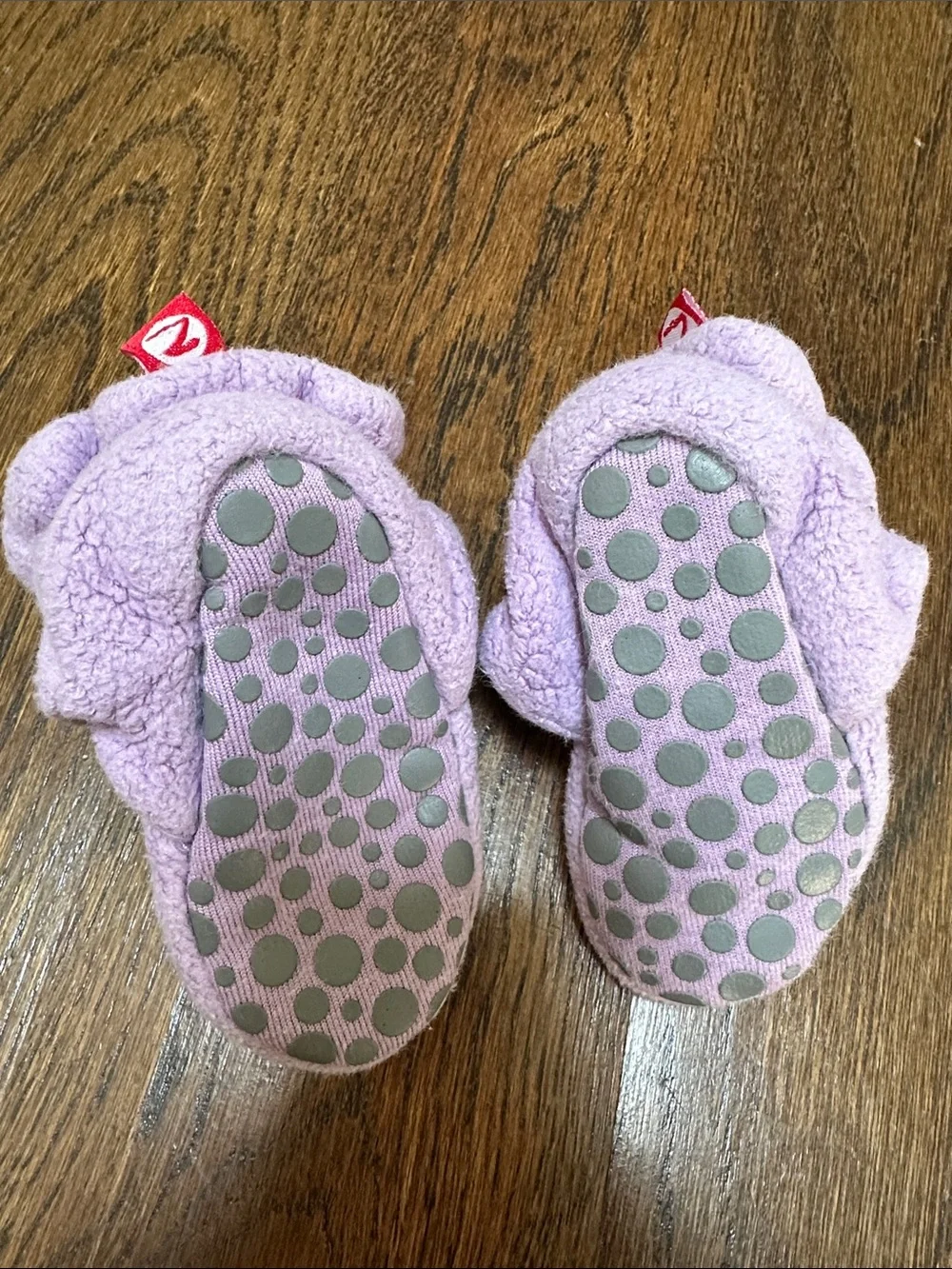 Two pairs of baby Zutano booties, 12M